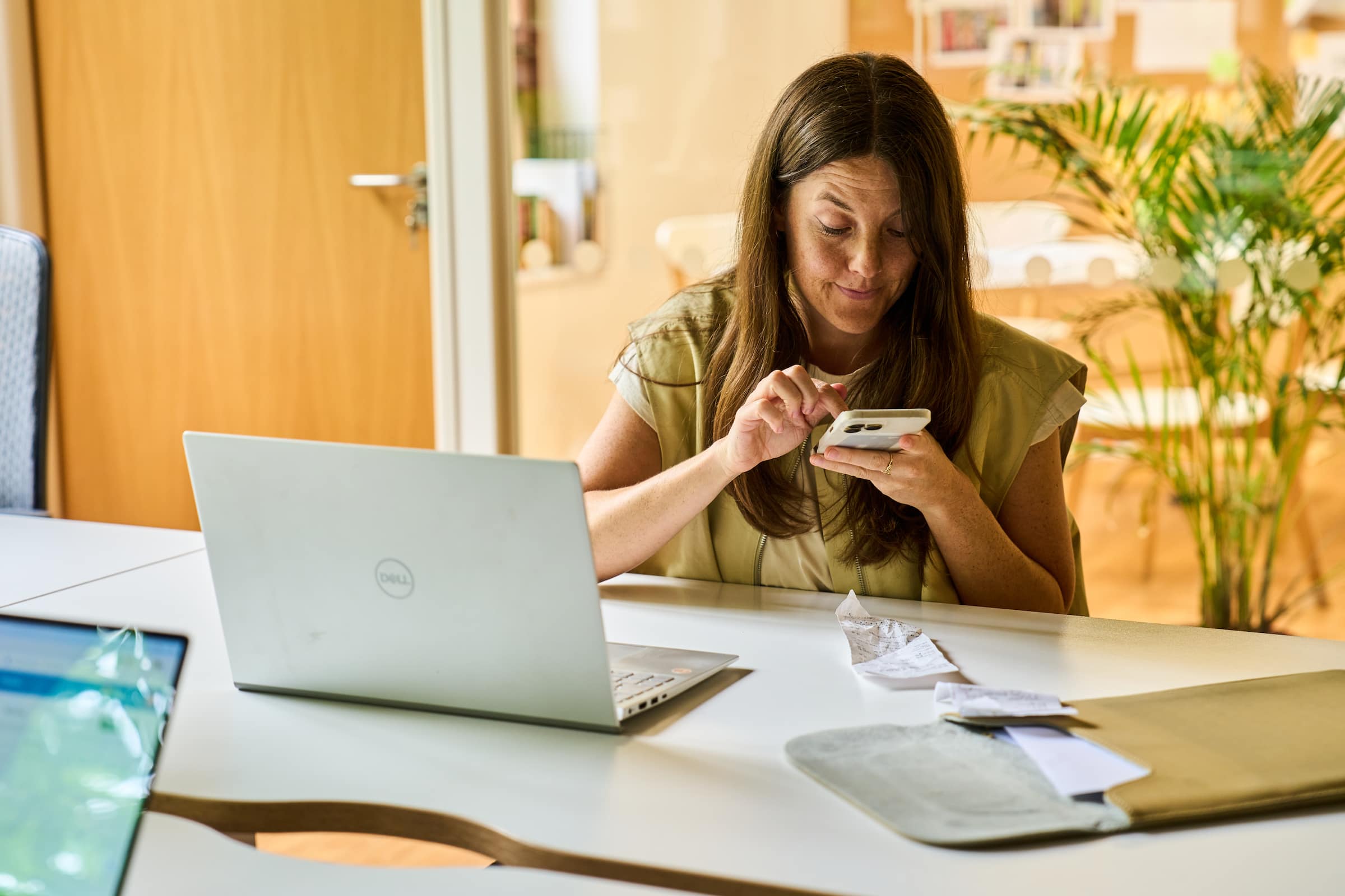 A small business owner uses Xero’s customer relationship management and stock control software on their phone. 